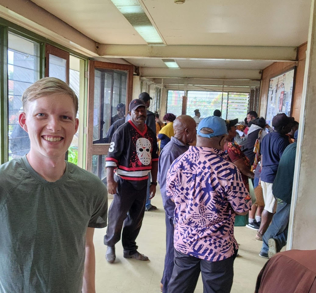 Noah Claasen with patients in a clinic hallway in Papua New Guinea